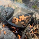 Traditional Swedish meatballs sizzling over an open fire – lunch break on our nature hike near Stockholm.