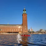 Moving past Stockholm City Hall on a relaxed kayak paddle