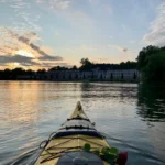 Excursión en kayak al atardecer pasando por el Palacio Karlbergs, luz dorada y aguas tranquilas