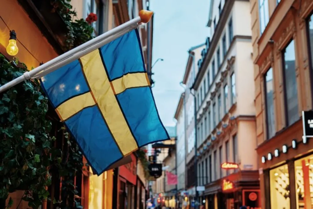 Walking tour through the old town of Stockholm, showing a Swedish flag in front